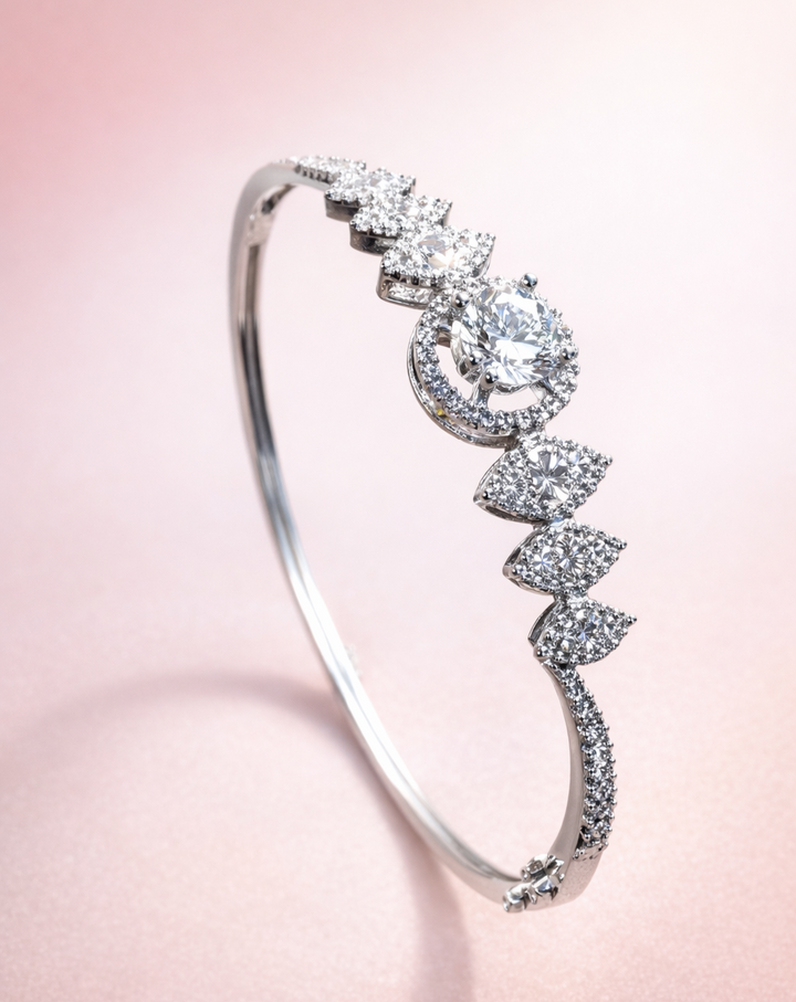 Silver bracelet with diamond accents on a pink background