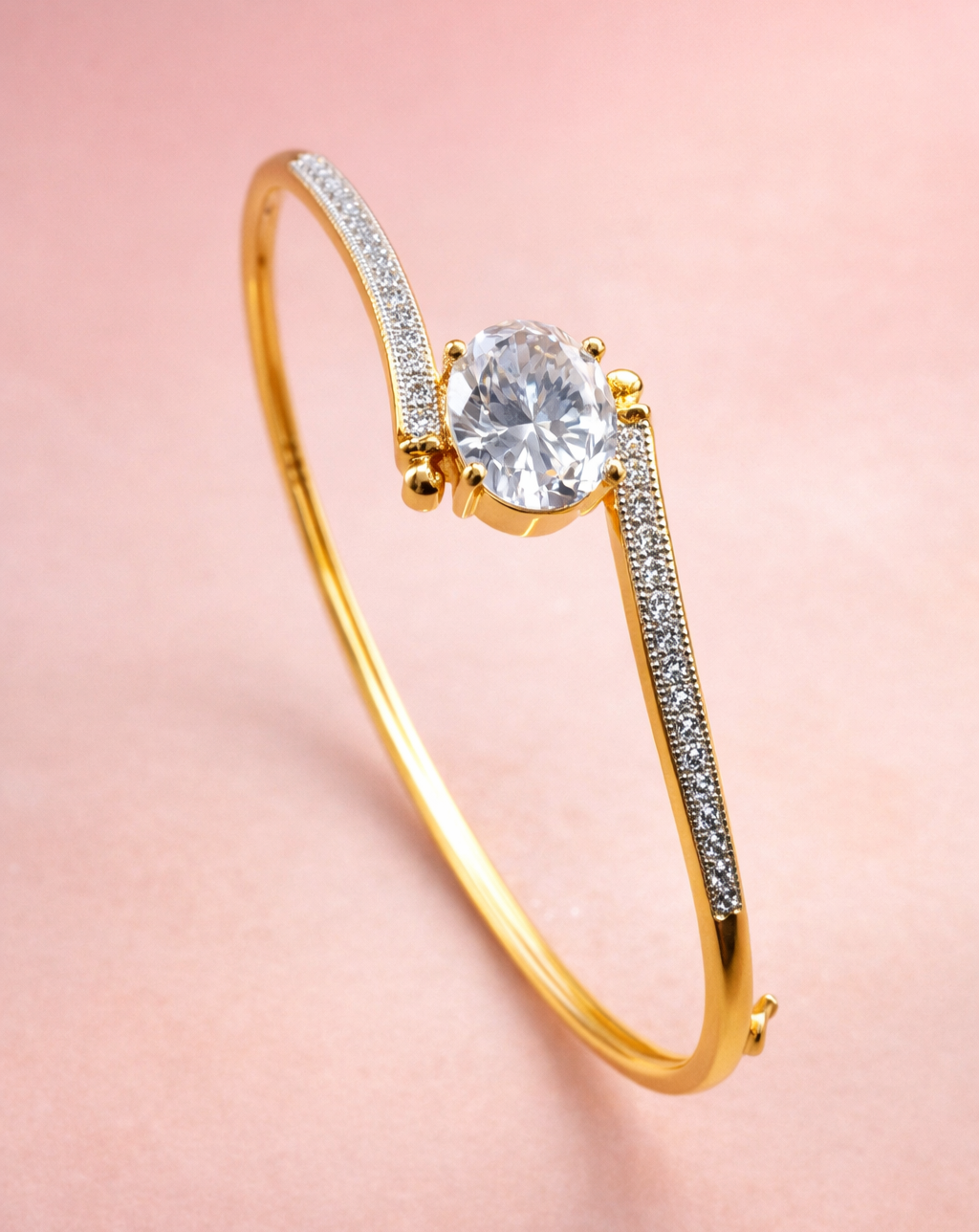Gold bracelet with a large diamond and smaller diamonds on a pink background