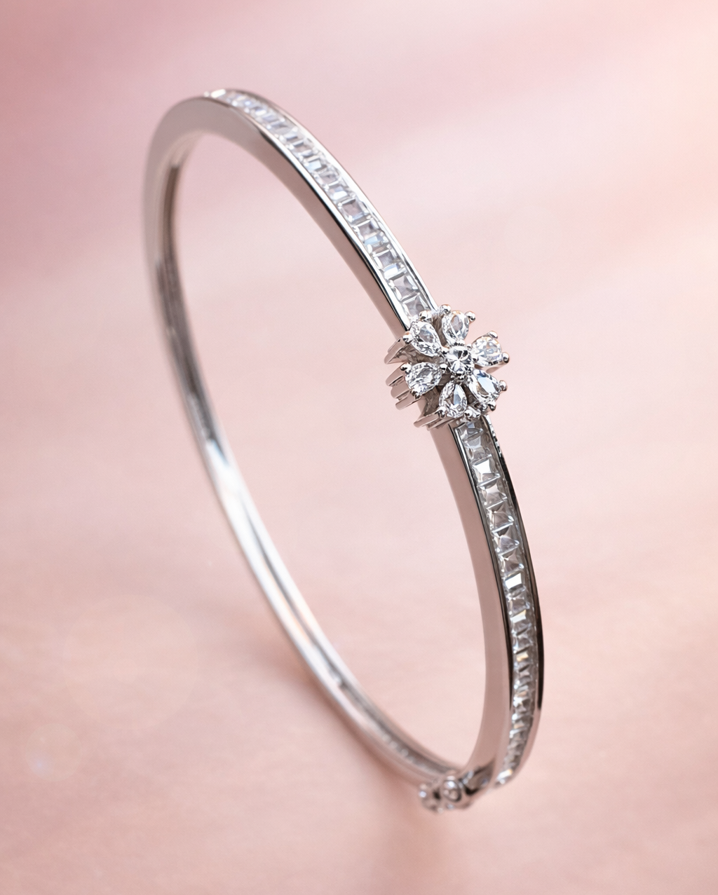 Silver bracelet with a diamond on a pink background