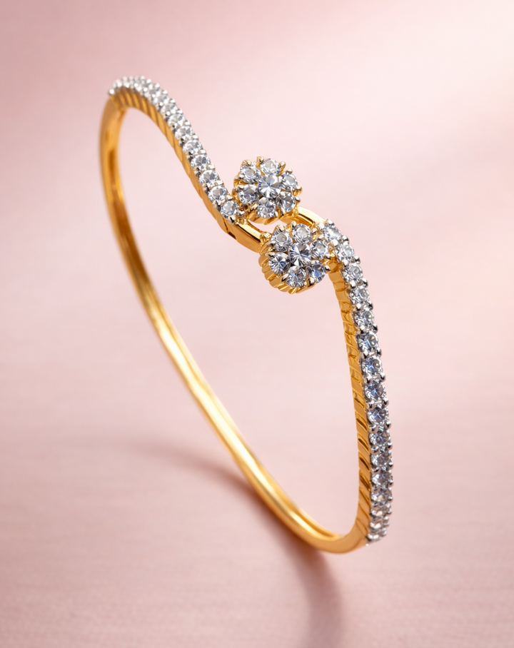 Gold bracelet with diamond accents on a pink background