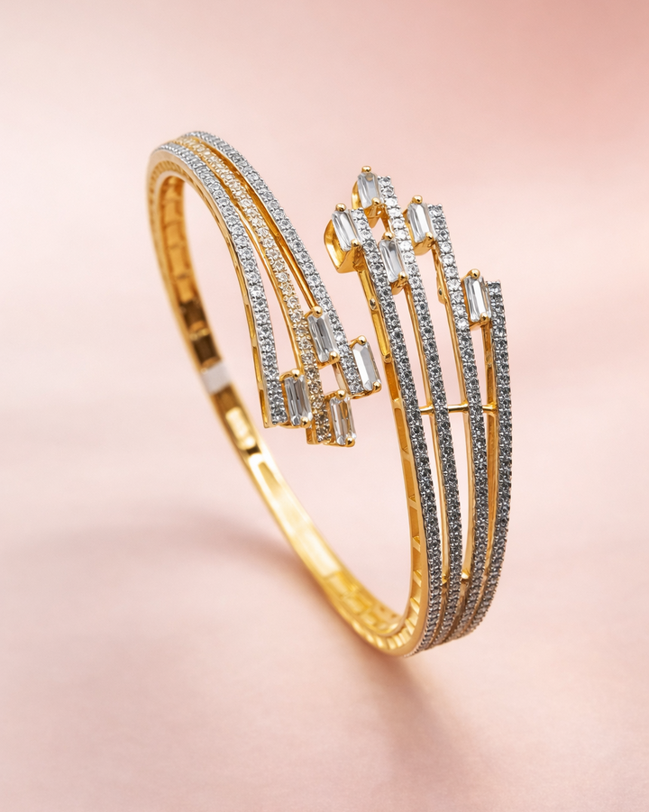 Gold bracelet with diamond accents on a pink background