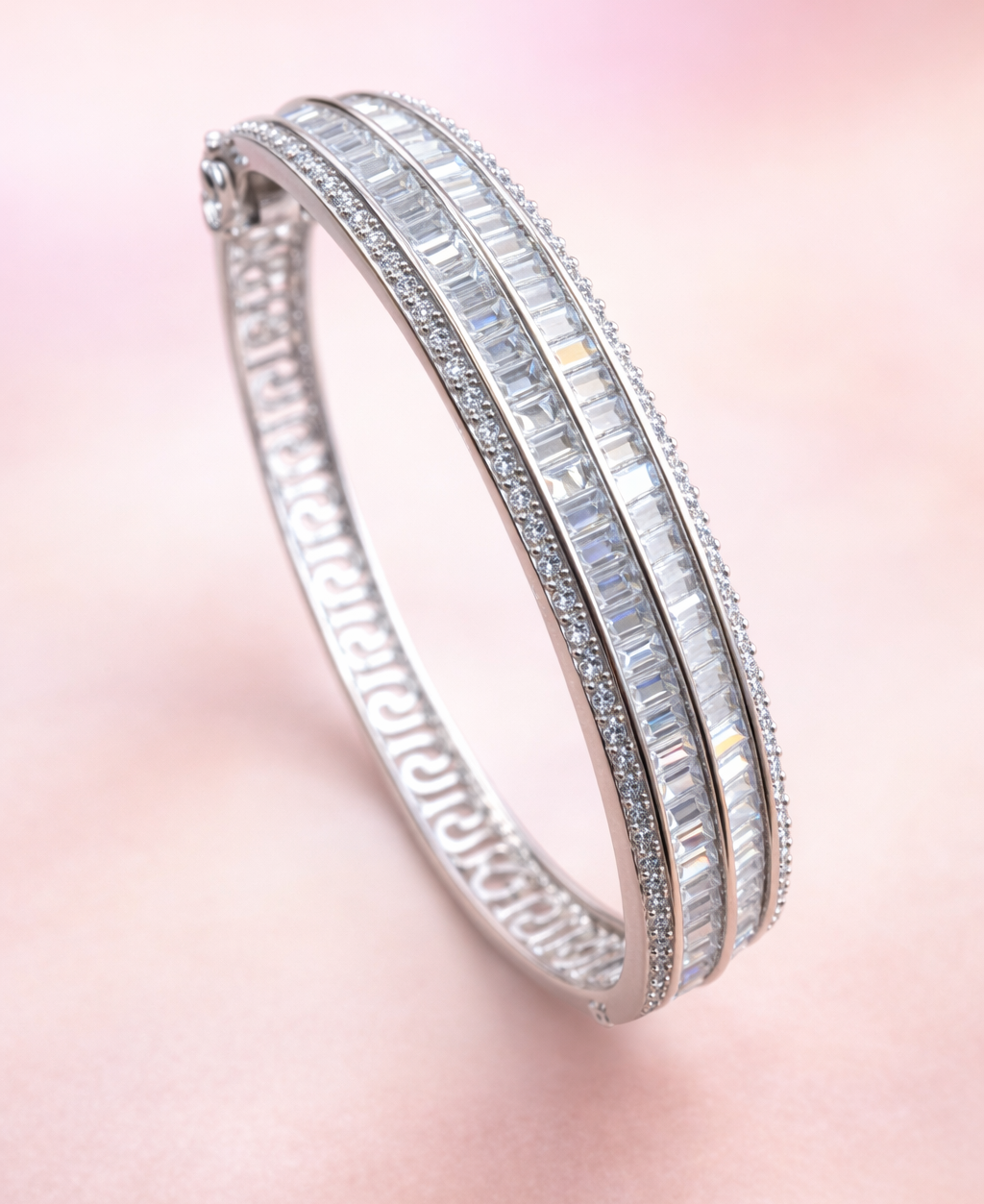 Silver bracelet with gemstones on a pink gradient background