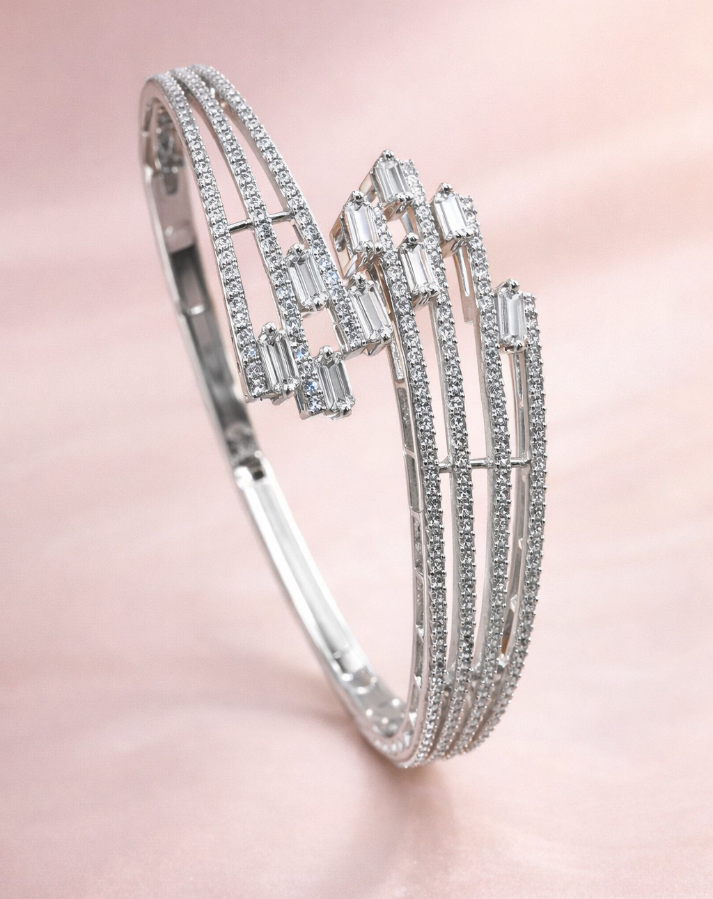 Silver bracelet with gemstones on a pink background