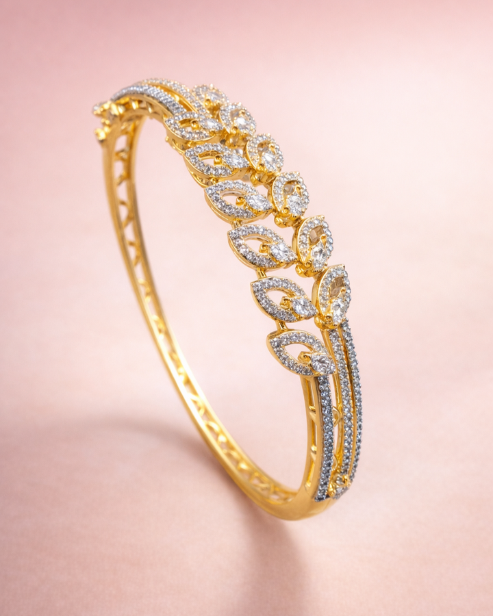 Gold bracelet with diamonds on a pink background