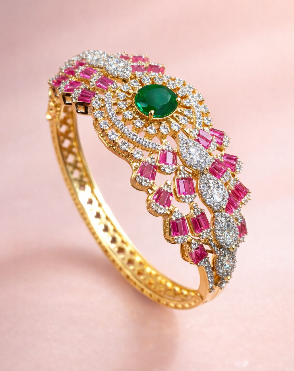 Gold bracelet with green gemstone and pink stones on a pink background
