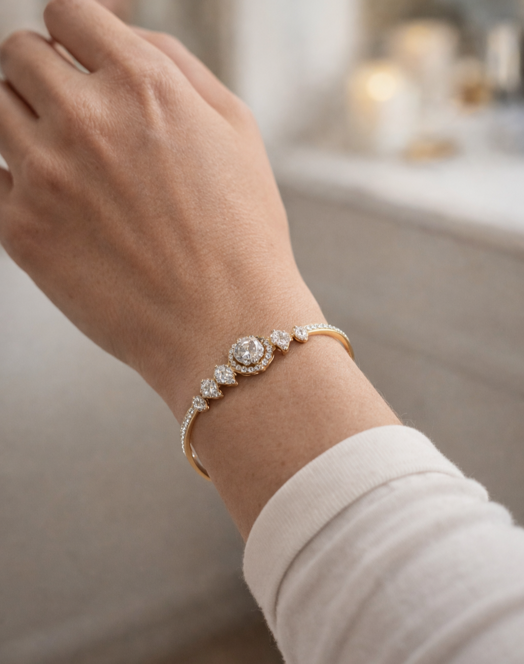 Close-up of a hand wearing a diamond bracelet with a blurred background