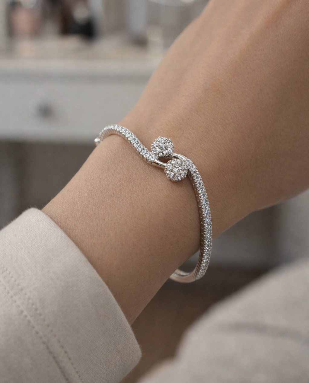 Silver bracelet with a clasp on a wrist, blurred background