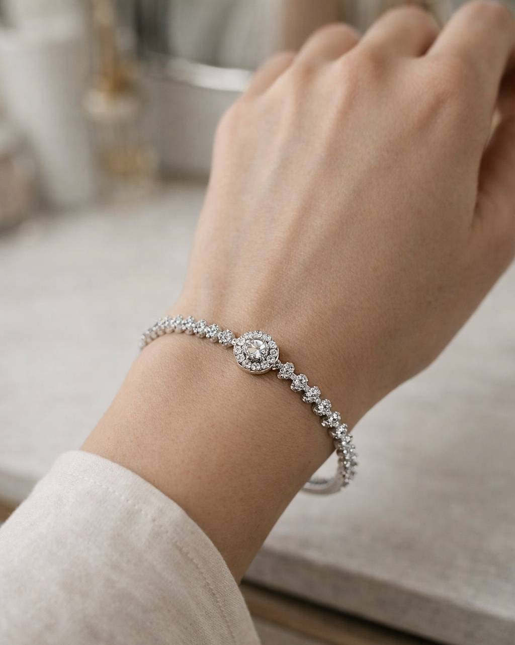 Silver bracelet on a wrist with a blurred background