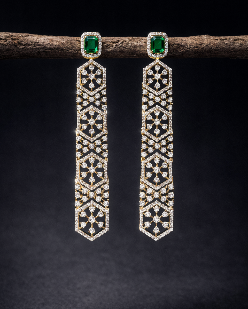 Pair of diamond earrings with green gemstones on a dark background
