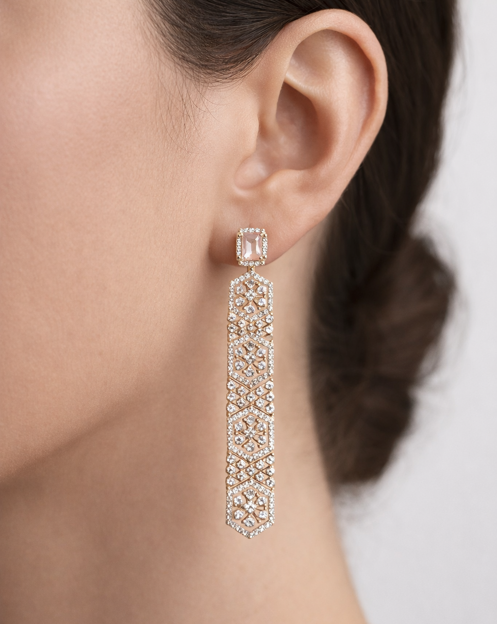 Earring worn by a person with a neutral background