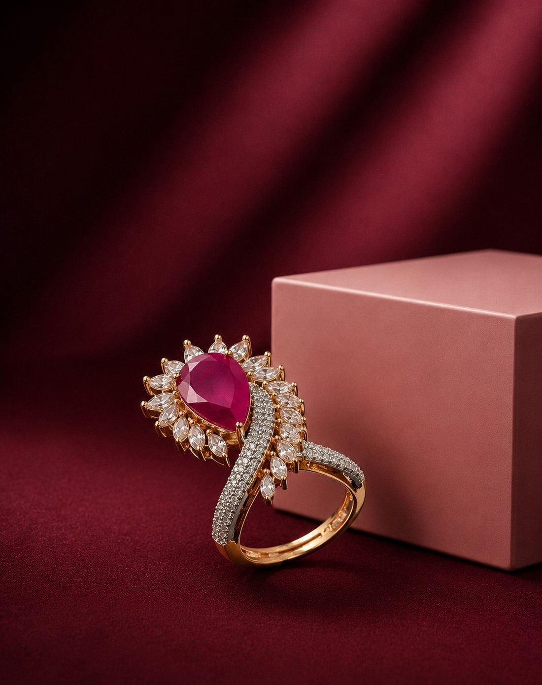 A luxurious gold-plated statement ring featuring a brilliant pear-cut CZ stone, floral halo detailing, and a sparkling pavé band for an elegant diamond-inspired look.