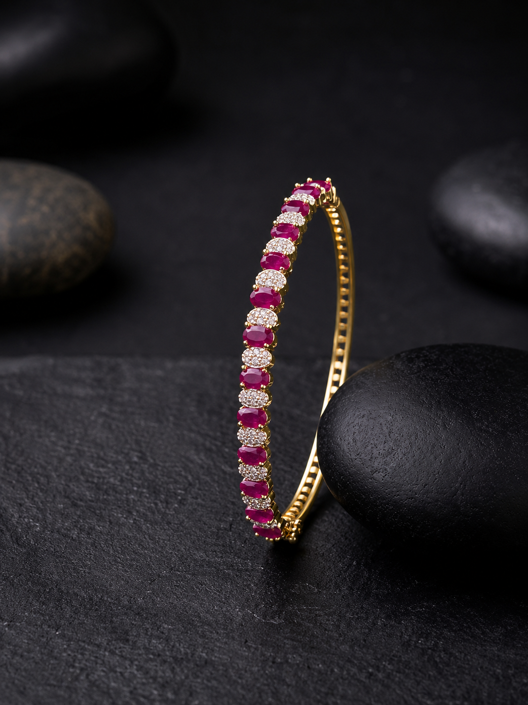A premium gold-plated available in emerald green and ruby red variants,
