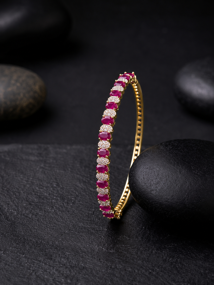 A premium gold-plated available in emerald green and ruby red variants,
