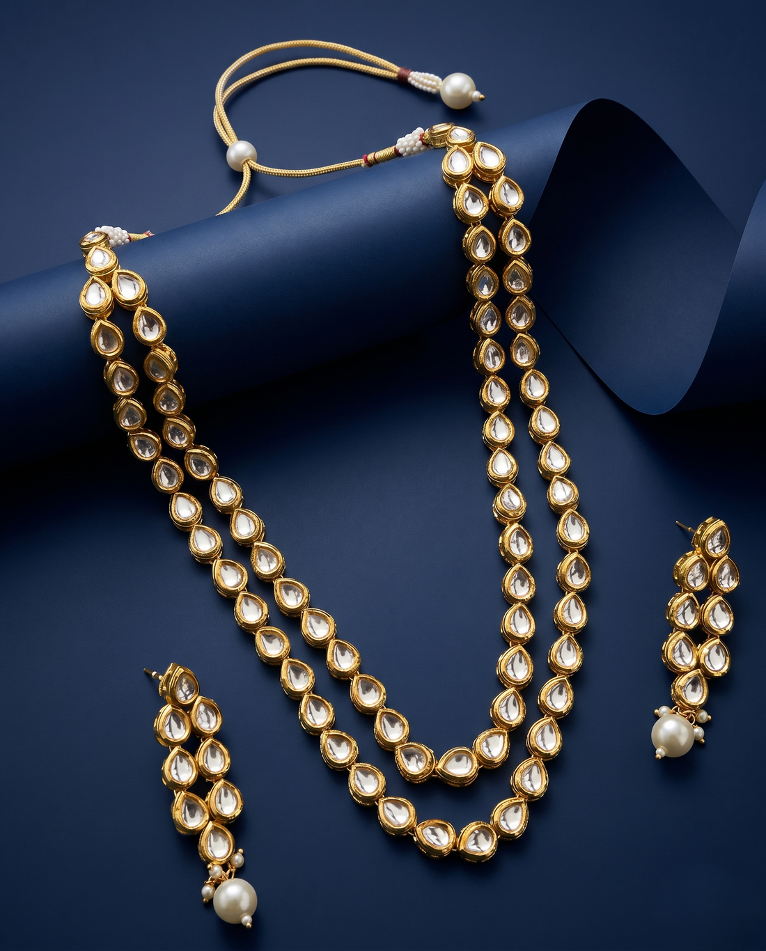 Antique Gold Double Line Kundan Necklace Set with Pearl Drop Earrings
with blue background 