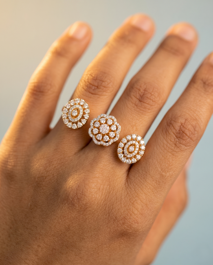 Close-up of a hand wearing two diamond stud earrings on a neutral background