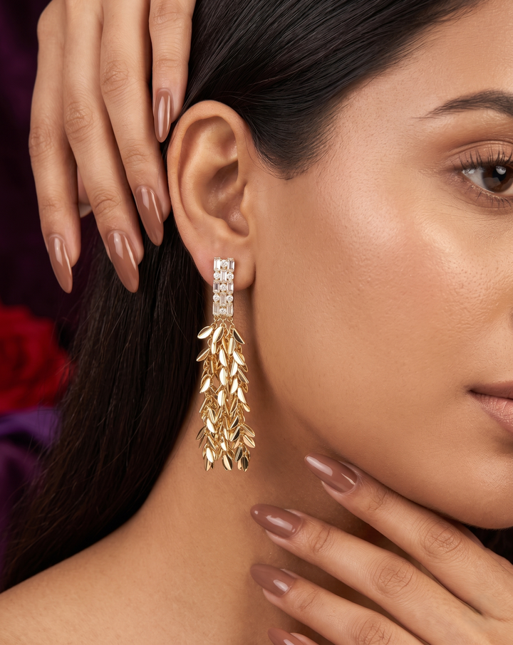 Close-up of a woman wearing gold earrings with a blurred background