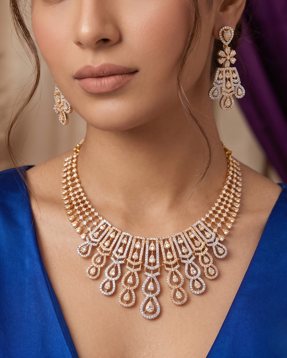Close-up of a woman wearing a gold necklace and earrings with a blurred background