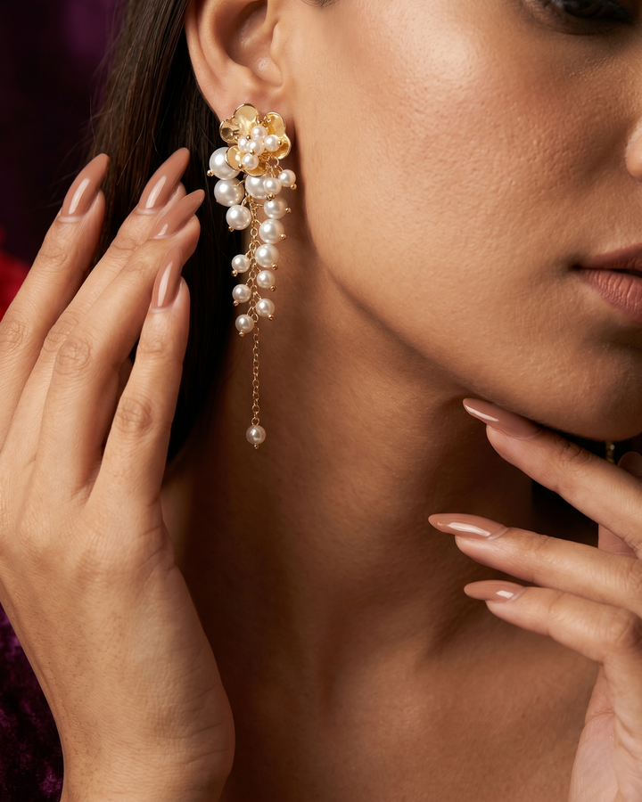 Close-up of a woman wearing a pearl earring with a blurred background