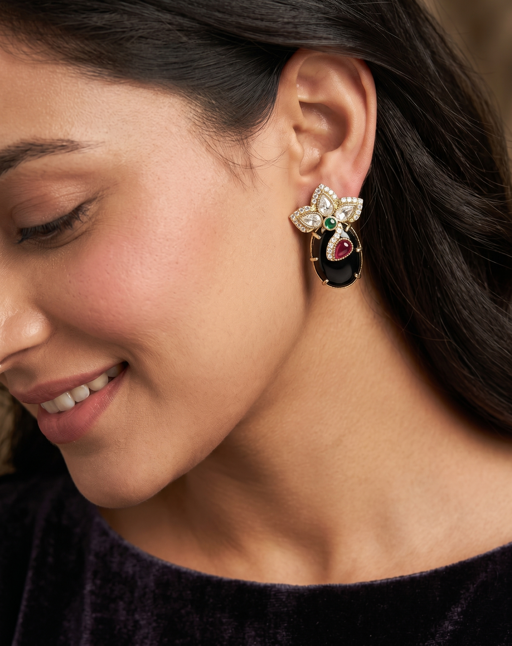 Close-up of a woman wearing an ornate earring with a dark background