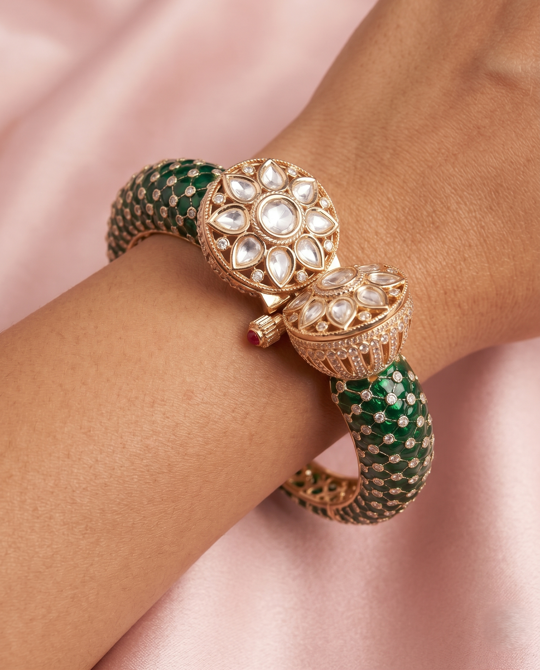 Decorative bracelet with green and gold design on a pink background