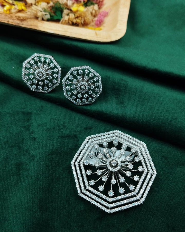 Decorative earrings on a green fabric background