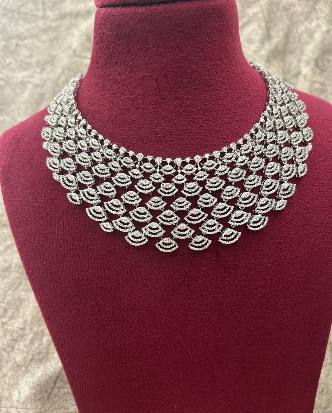 Diamanté necklace on a mannequin bust with a textured background