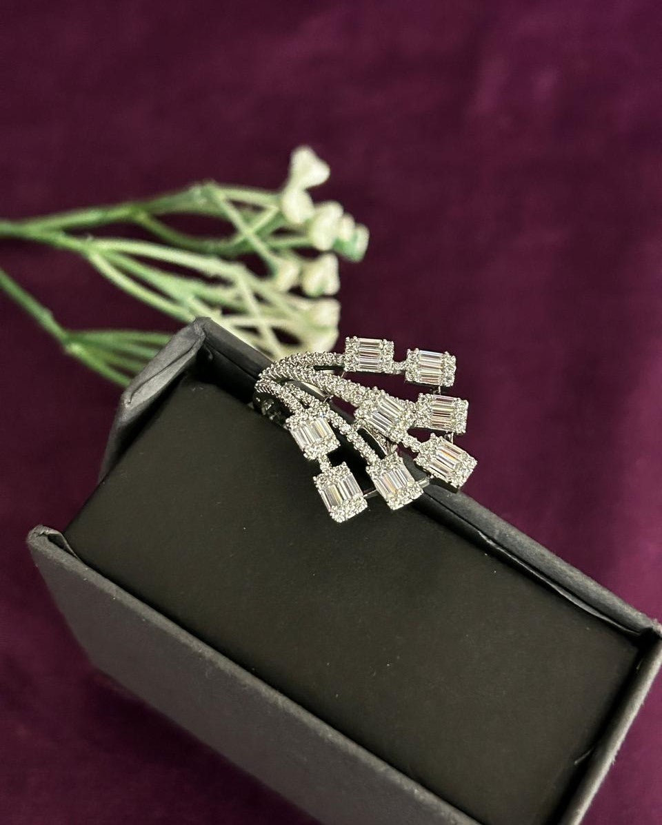 Diamond earring in a black box with a purple background