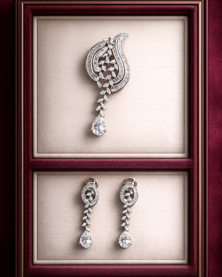 Diamond earrings displayed in a jewelry box with a maroon frame.