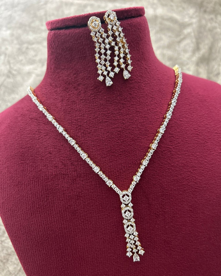 Diamond necklace and earrings on a mannequin bust with a textured background