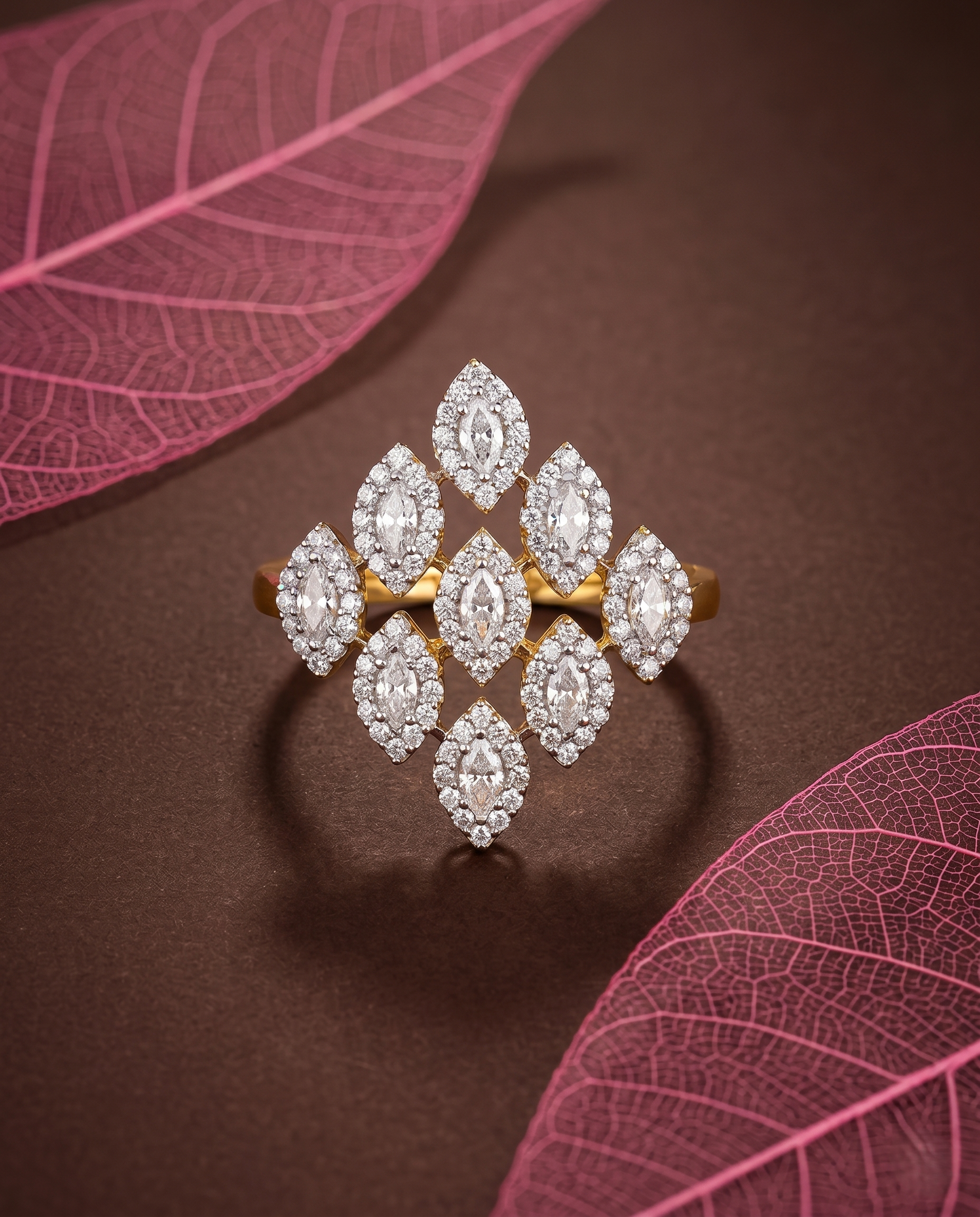 Diamond ring with gold setting on a brown background with pink leaves