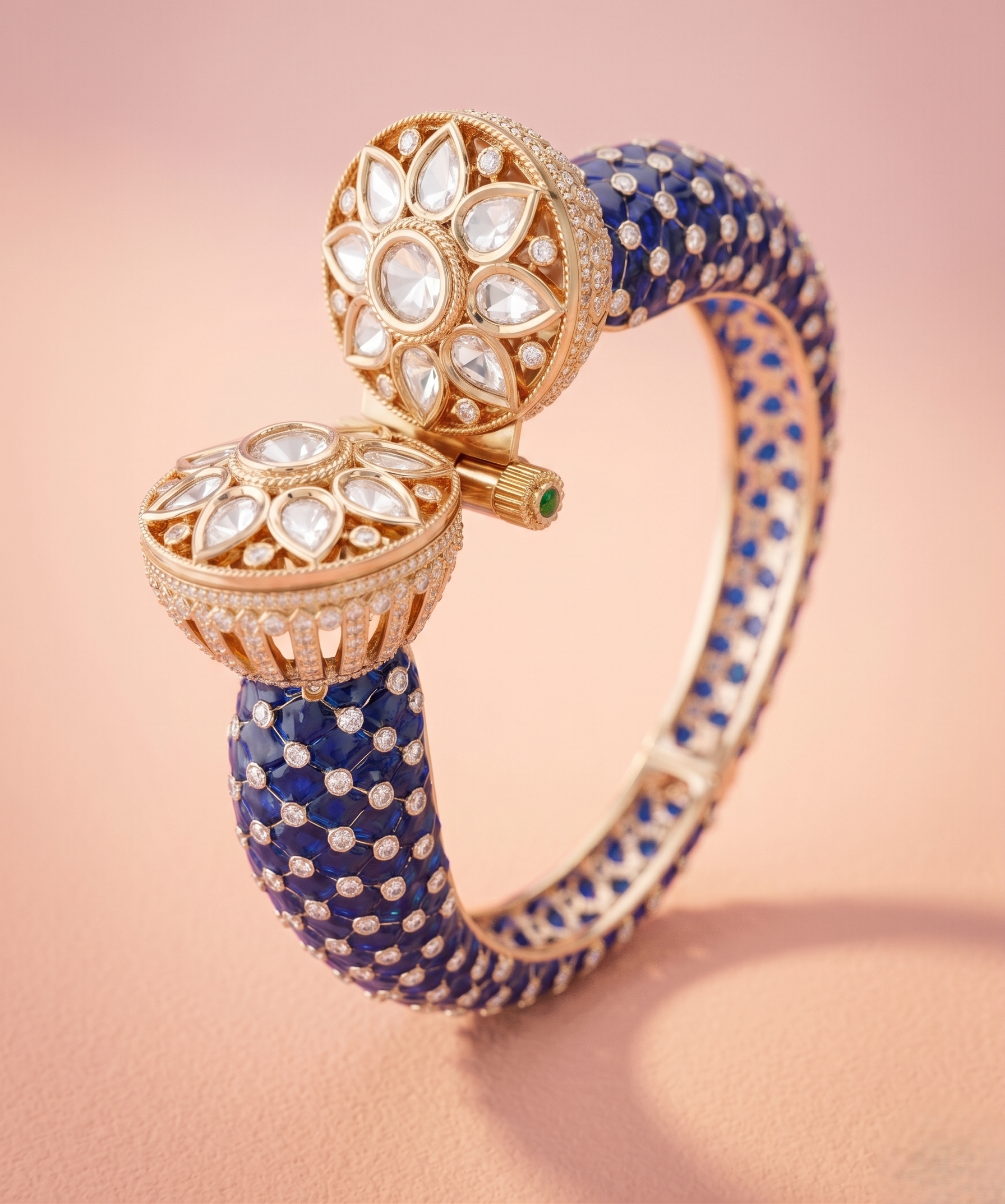 Elegant blue and gold bracelet with intricate design on a pink background