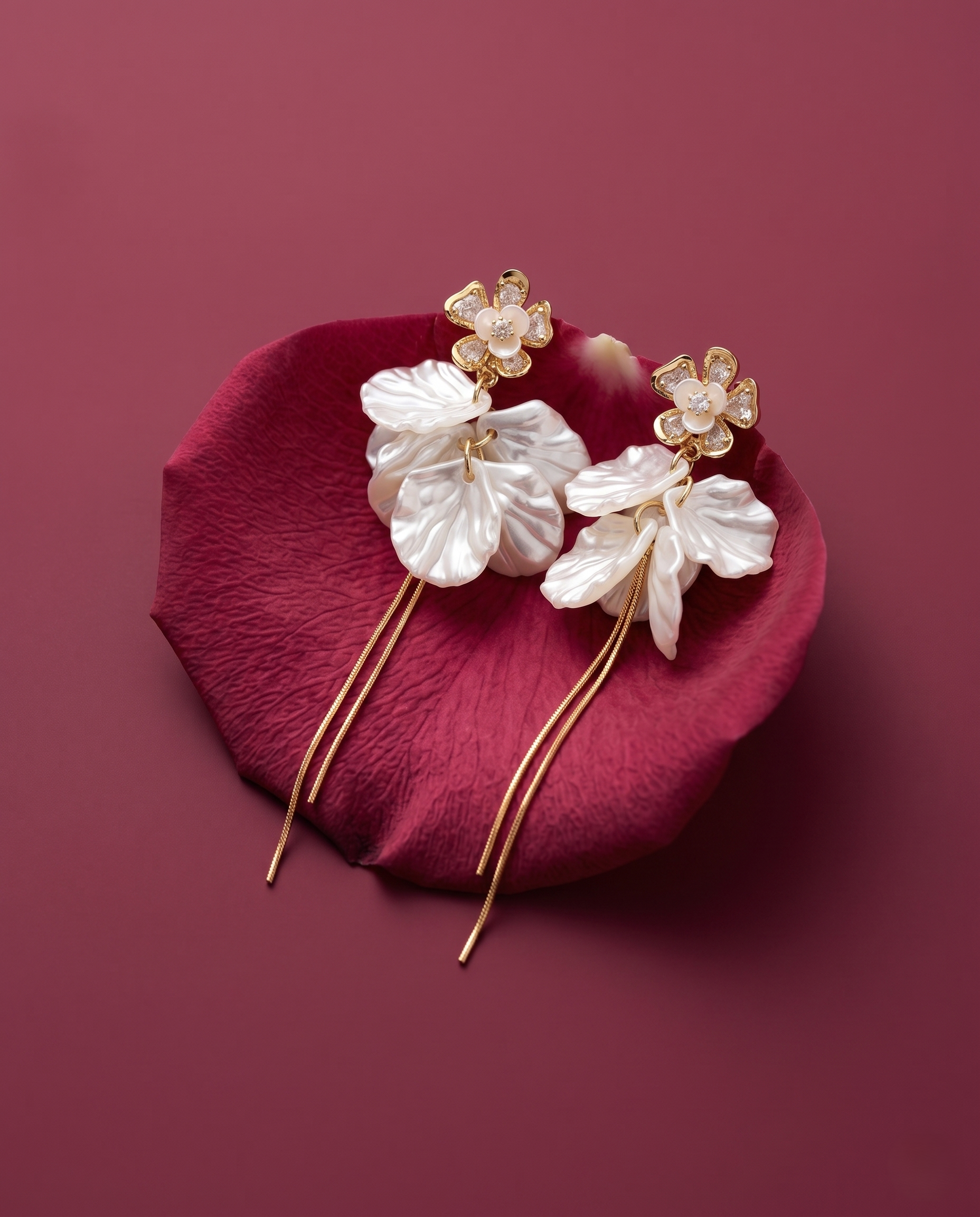 Floral hairpin with gold accents on a red petal against a maroon background