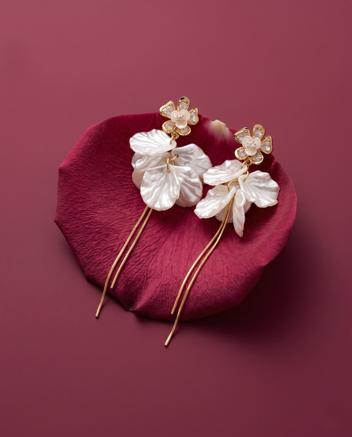 Floral hairpin with gold accents on a red petal against a maroon background