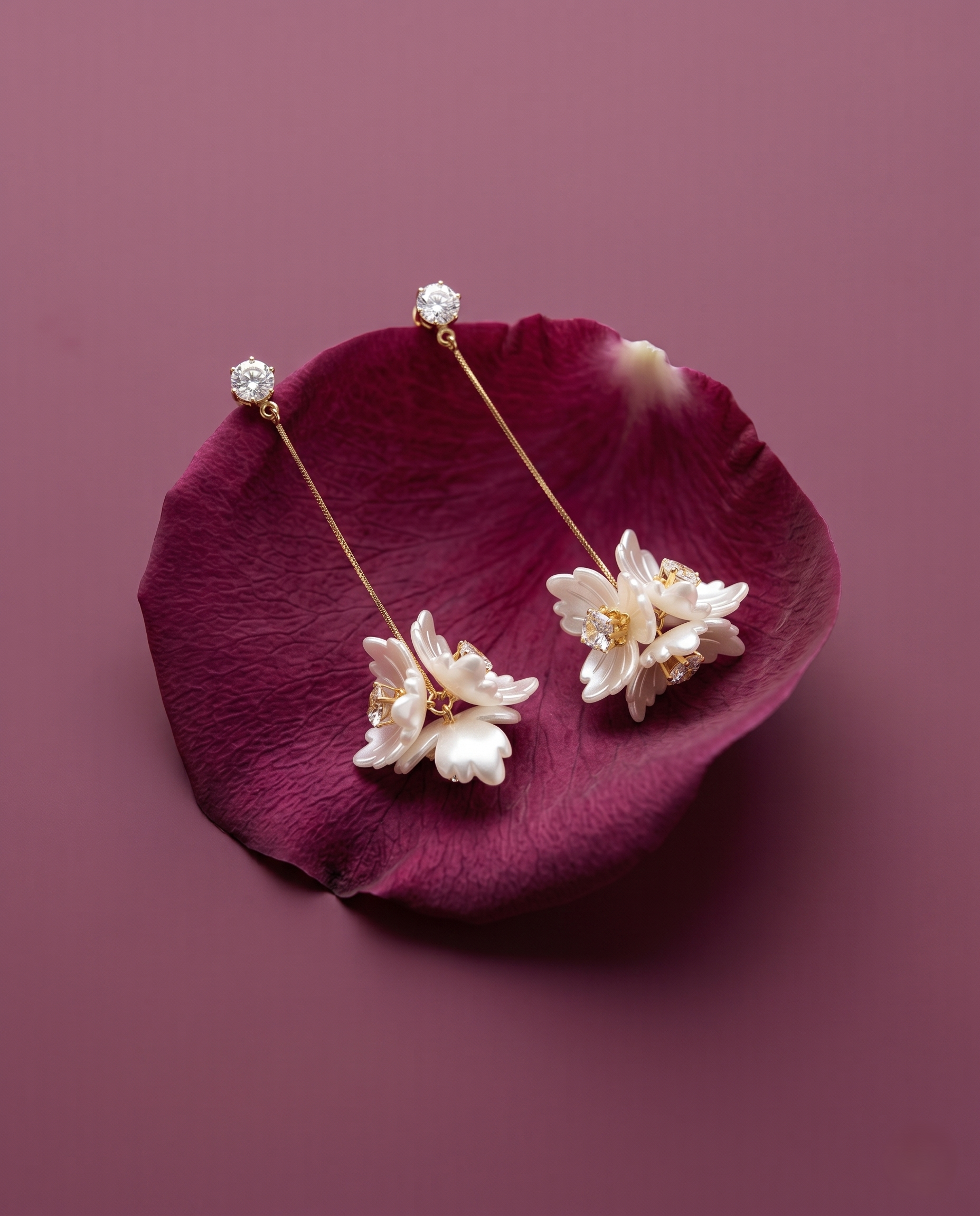 Floral earrings on a purple petal with a purple background
