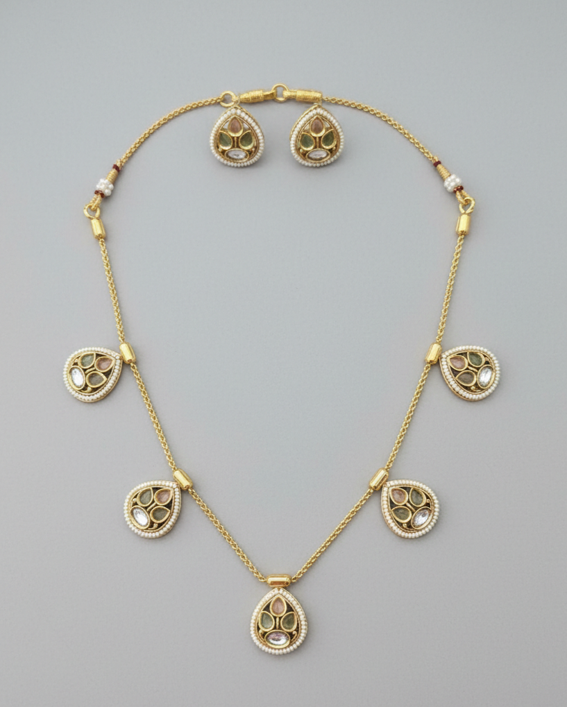 Gold necklace with pendant on a gray background