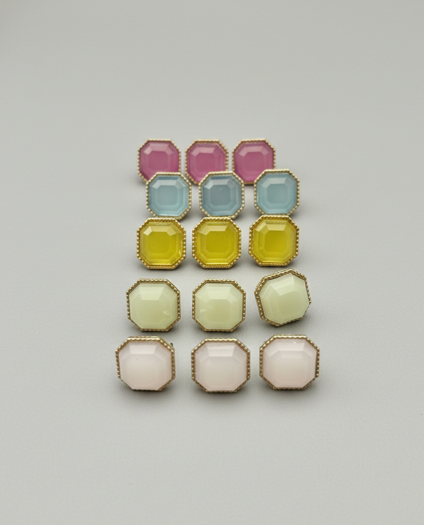 Set of colorful geometric earrings on a light gray background