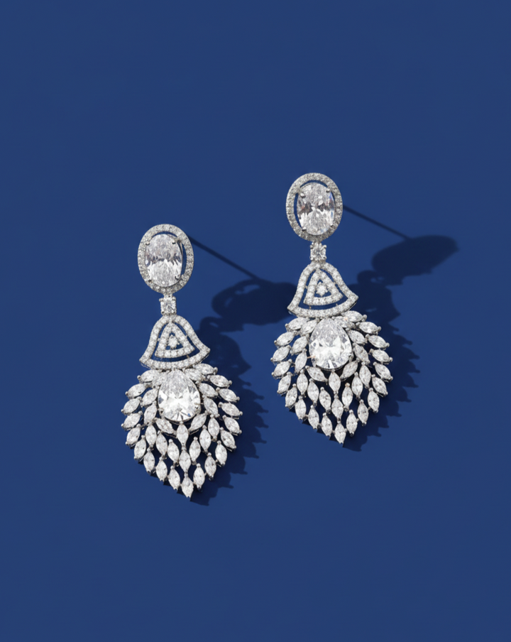 Pair of diamond earrings on a blue background