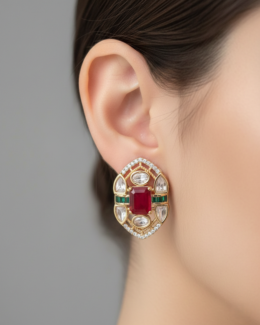 Close-up of an ear wearing a decorative earring with gemstones on a neutral background