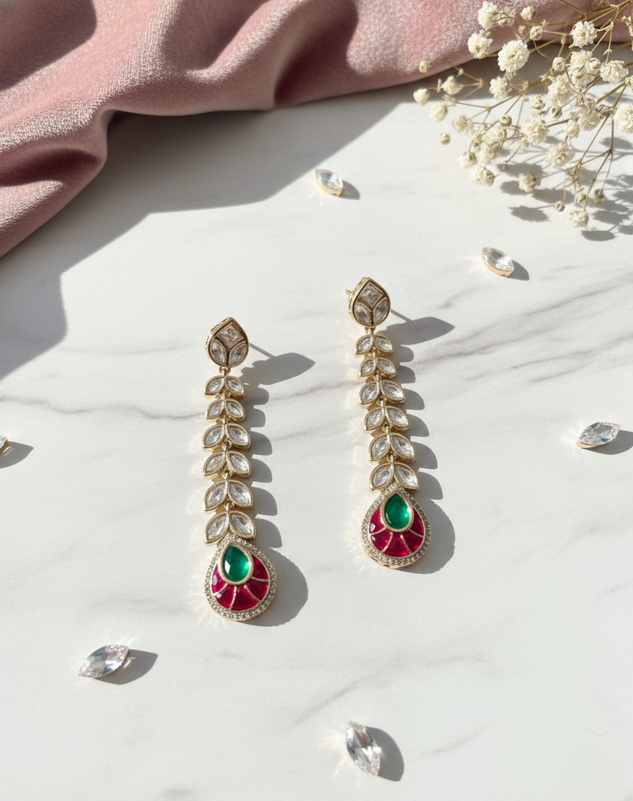Ornate earrings with gemstones on a light surface with flowers