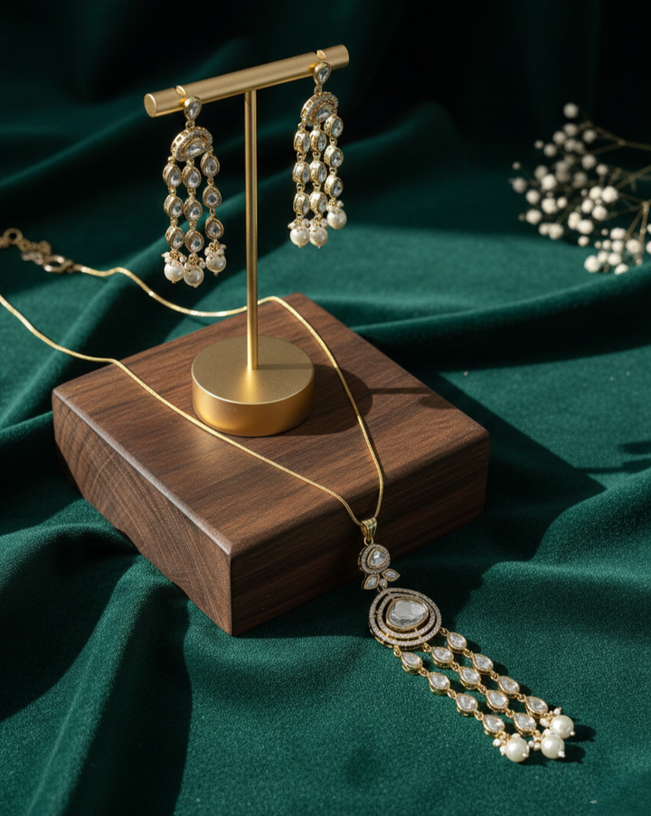 Decorative earrings on a wooden stand with a green fabric background