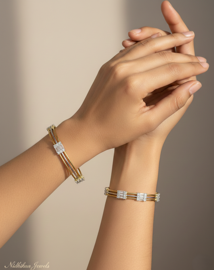 Gold bracelet with clear stones on a wrist against a neutral background