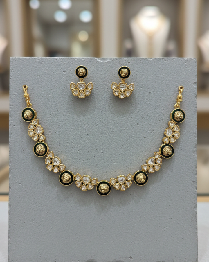 Necklace and earrings set on a gray stand with blurred background