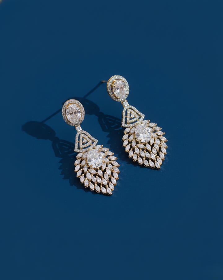 Pair of diamond earrings on a dark blue background