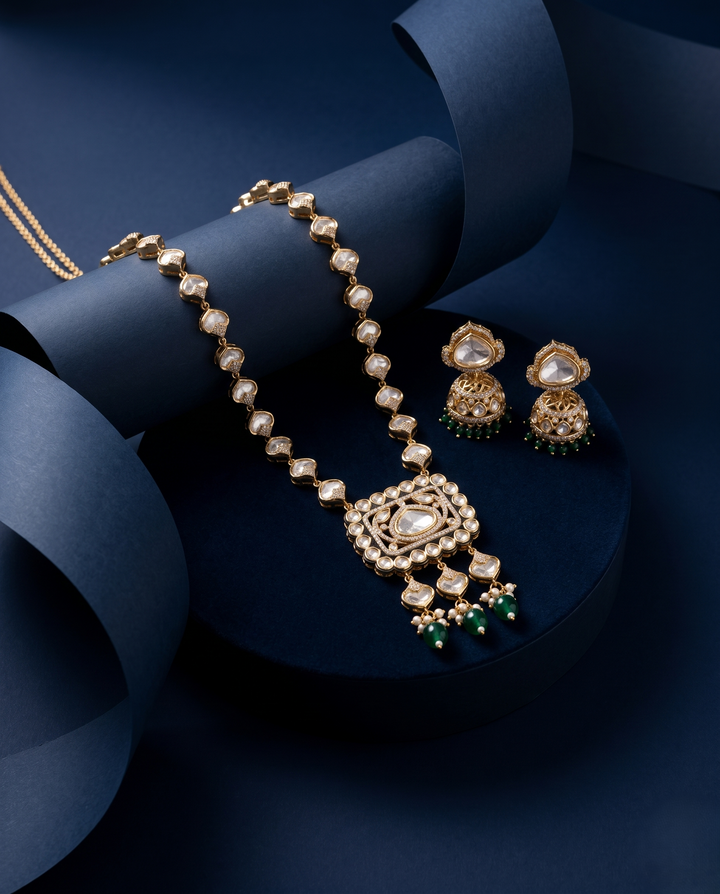 Gold Finish Kundan Long Necklace Set with Jhumka Earrings & Green Drops
with blue background 