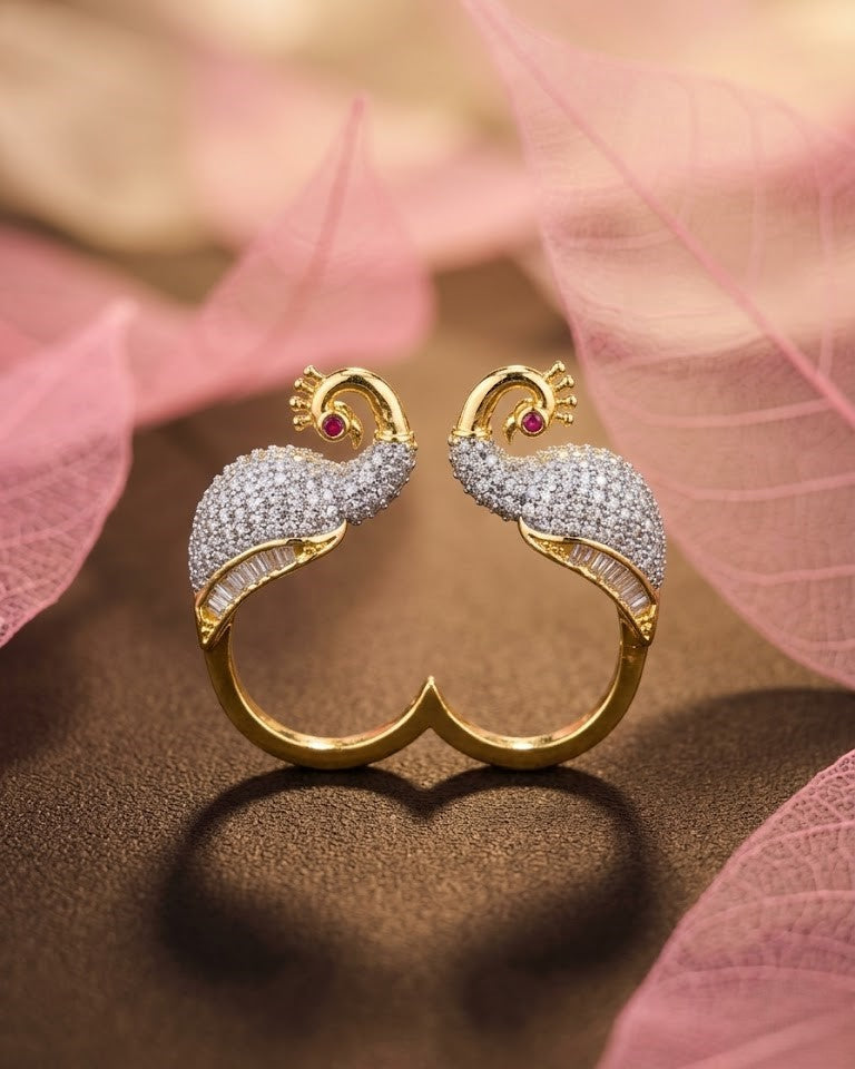 Gold and diamond Swan-shaped earrings on a pink leaf background