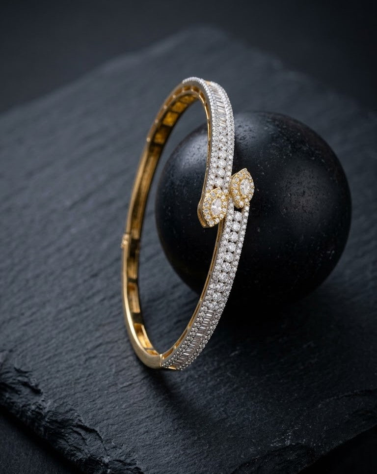 Gold and diamond bracelet on a dark stone surface