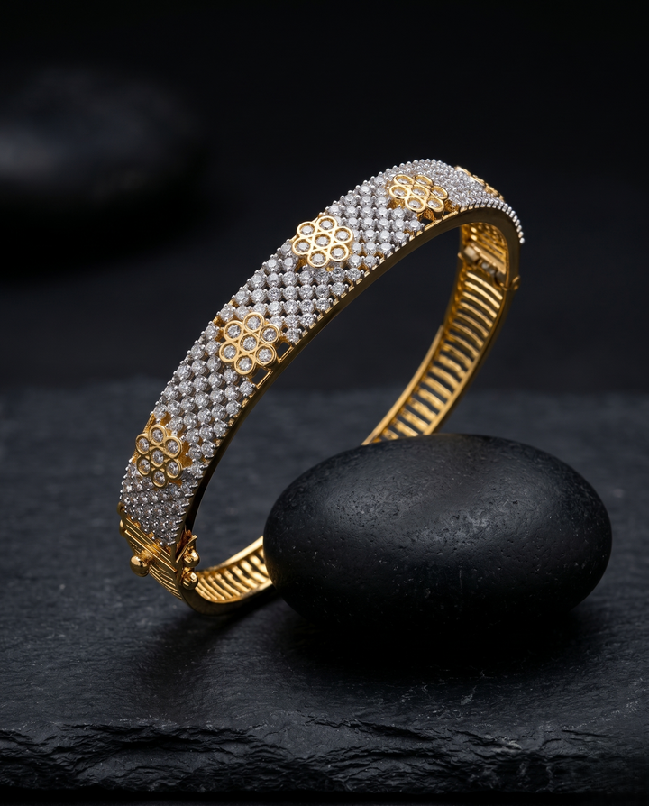 Gold and diamond bracelet on a dark stone surface