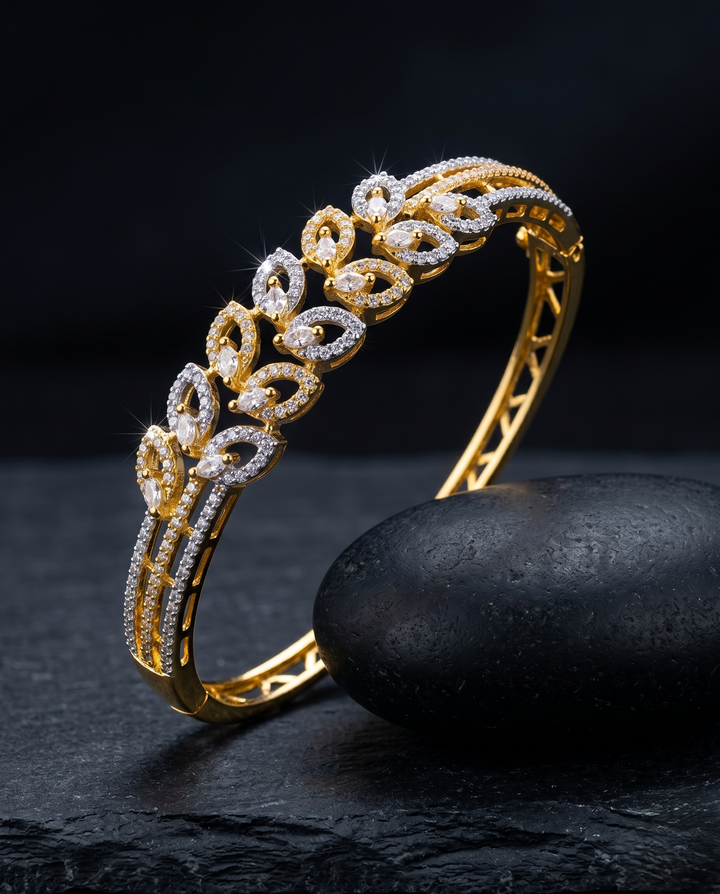 Gold and diamond bracelet on a dark stone surface with a black background
