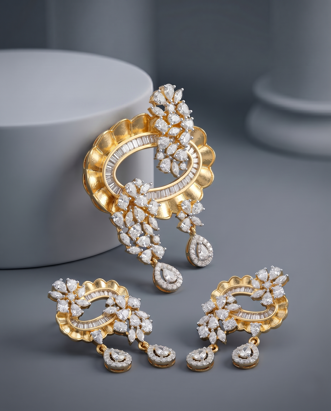 Gold and diamond earrings on a gray background