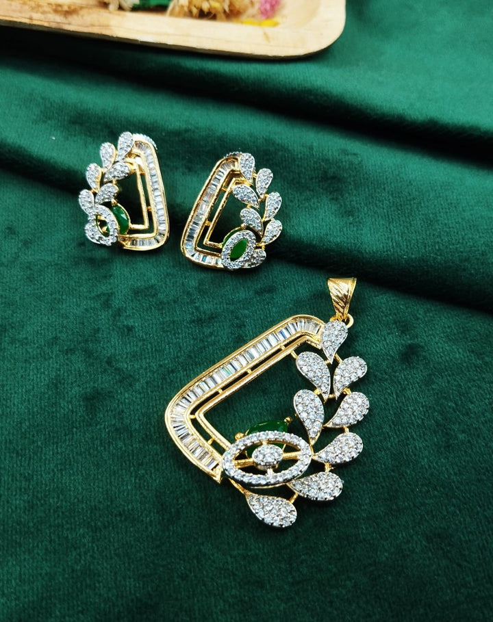 Gold and diamond jewelry set on a green fabric background